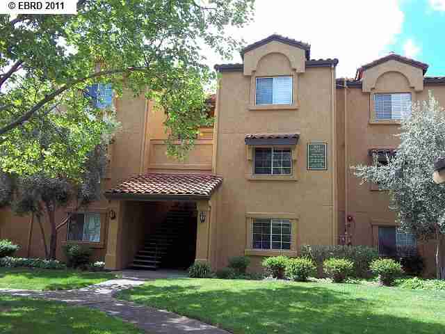 805 Watson Canyon Court, Unit 260 San Ramon, CA 94582 - Photo 1 of 1 a view of a brick house with a yard and large tree