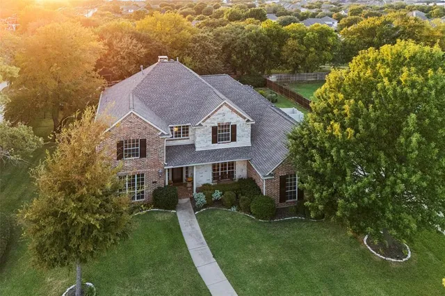 a aerial view of a house next to a yard