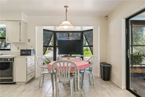 a view of a dining room with furniture window and outside view