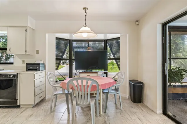 a view of a dining room with furniture window and outside view