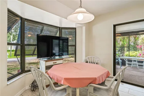a dining room with a table chairs and a flat screen tv