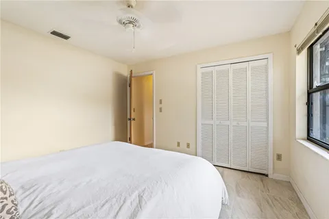 a spacious bedroom with a bed and a window