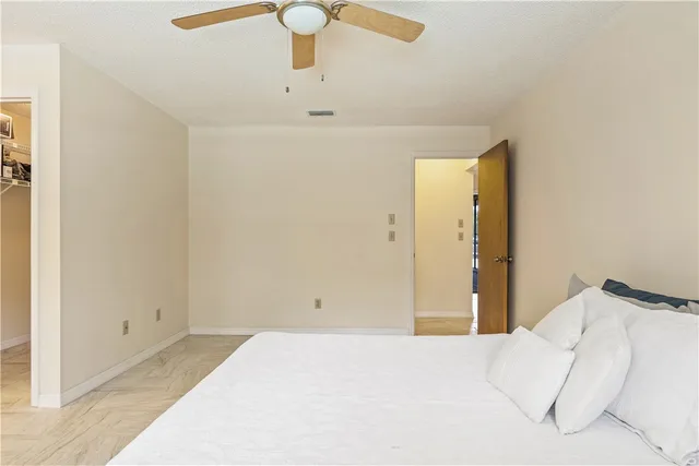 a bedroom with a bed and a lamp