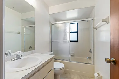 a bathroom with a sink toilet tub and shower