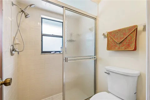 a bathroom view of a shower and a toilet