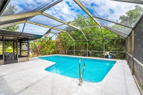 a view of a backyard with swimming pool