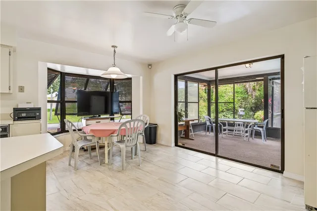 a dining room with furniture a chandelier and a rug