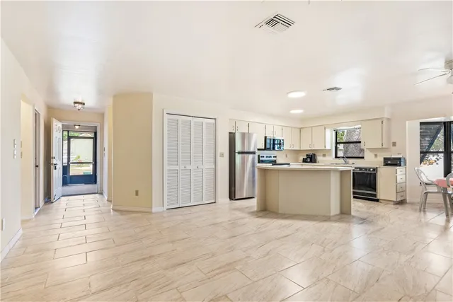 a view of kitchen with refrigerator and cabinets