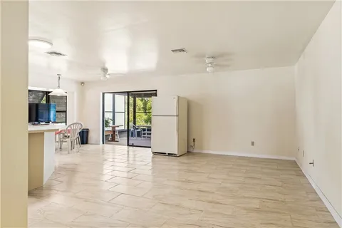 an entryway of a room with wooden floor and windows