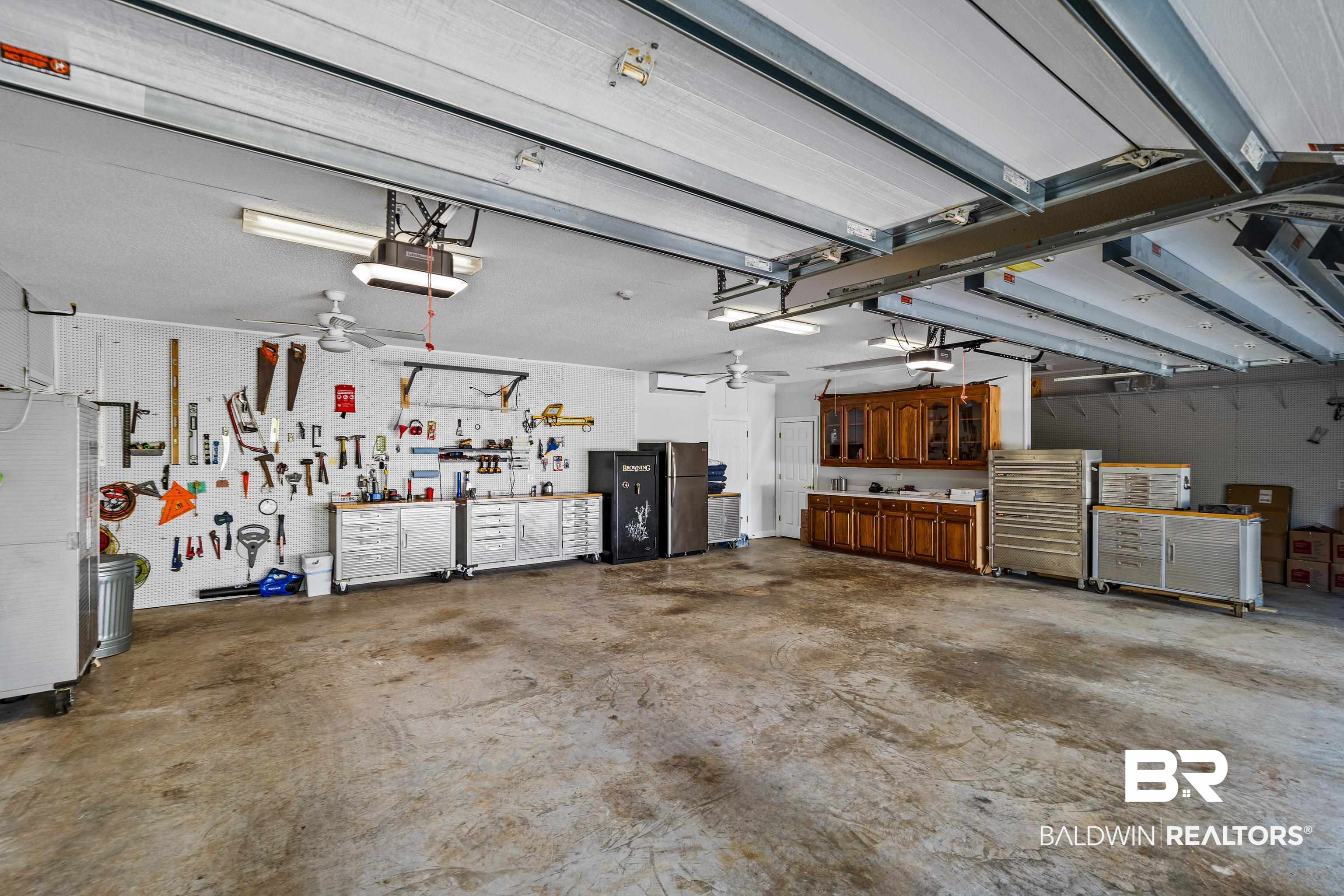 31267 Blakeley Ridge Court Spanish Fort, AL 36527 - Photo 55 of 61 Garage with a garage door opener, ceiling fan, and a workshop area