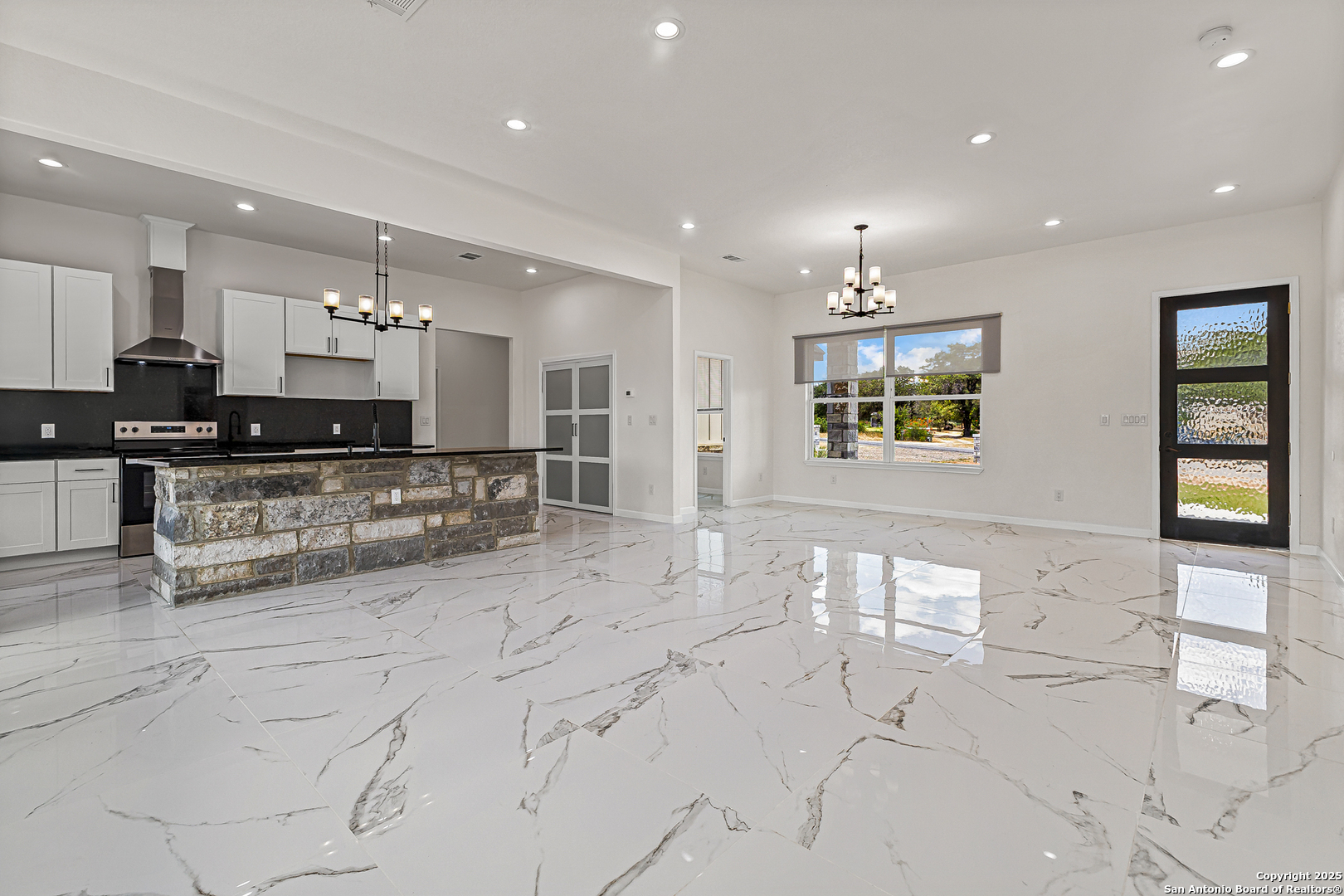 120 County Road 6852 Lytle, TX 78052 - Photo 13 of 36 a large kitchen with stainless steel appliances kitchen island granite countertop a large counter top and a stove top oven