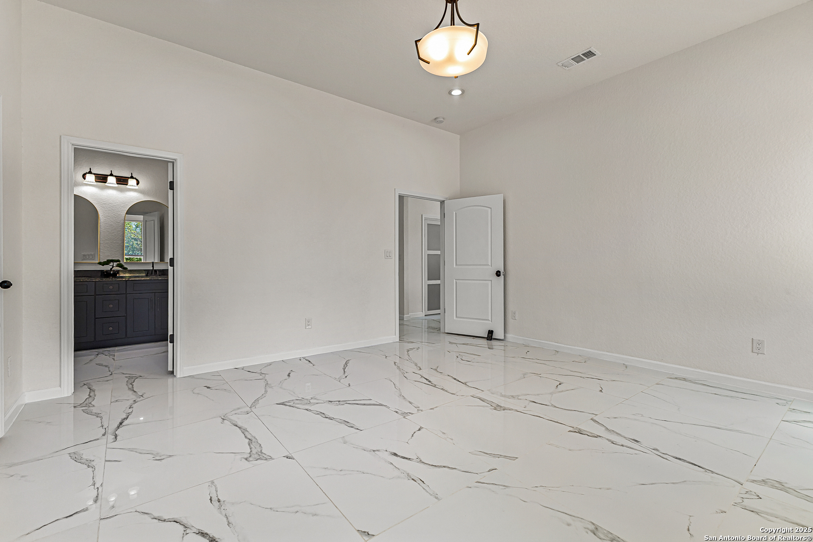 120 County Road 6852 Lytle, TX 78052 - Photo 19 of 36 an empty room with chandelier