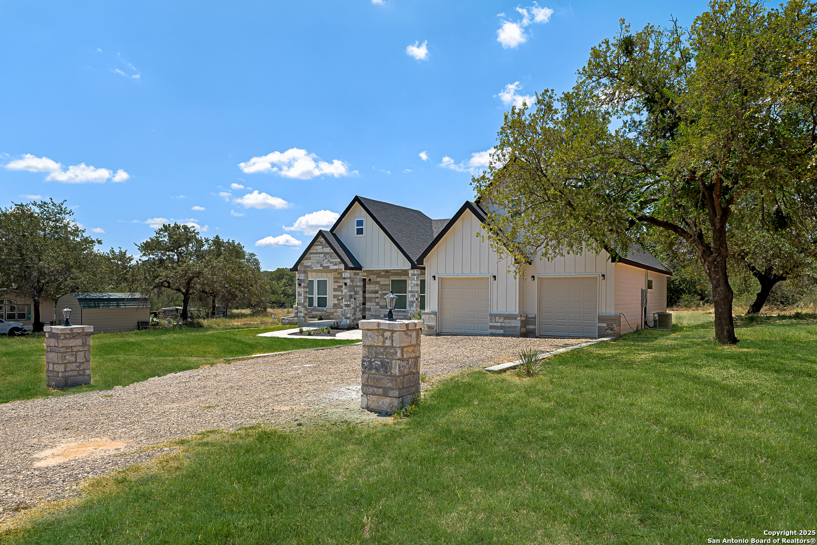 120 County Road 6852 Lytle, TX 78052 - Photo 29 of 36 a front view of a house with a yard and garage