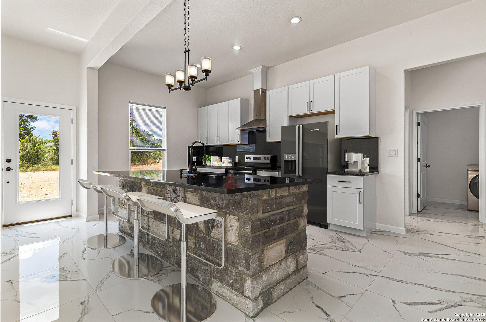 120 County Road 6852 Lytle, TX 78052 - Photo 6 of 36 a kitchen with stainless steel appliances granite countertop a stove refrigerator and microwave