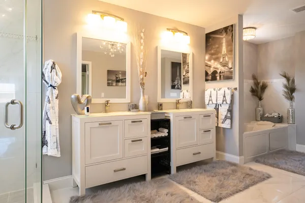 a spacious bedroom with a bed and a flat screen tv
