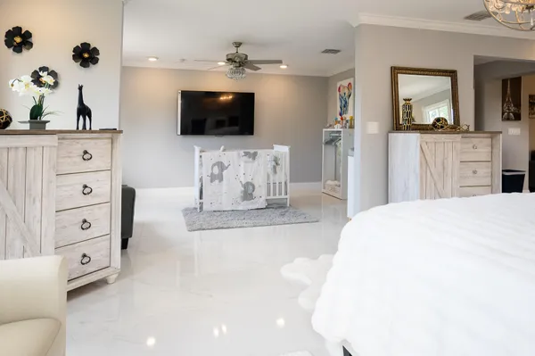a bedroom with a bed and painting on the wall