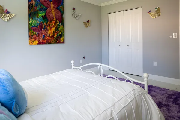 a bedroom with a bed and dresser