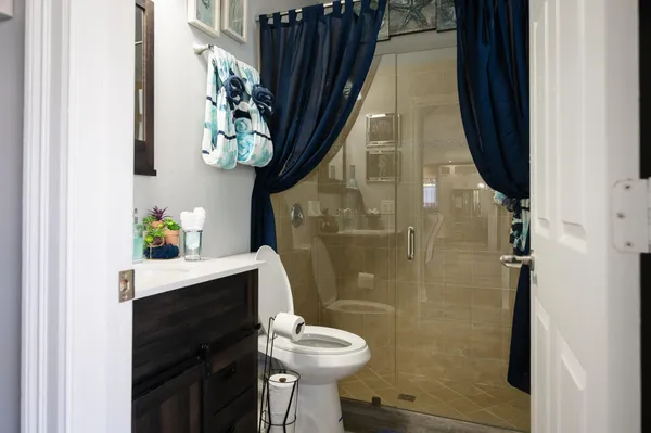 a bathroom with a sink toilet and shower