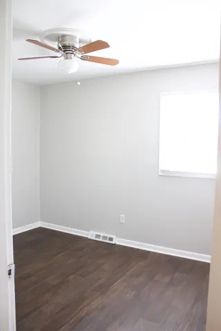 a view of a room with wooden floor