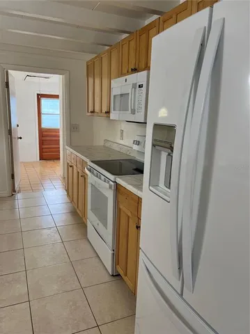 a kitchen with a stove a refrigerator and a sink