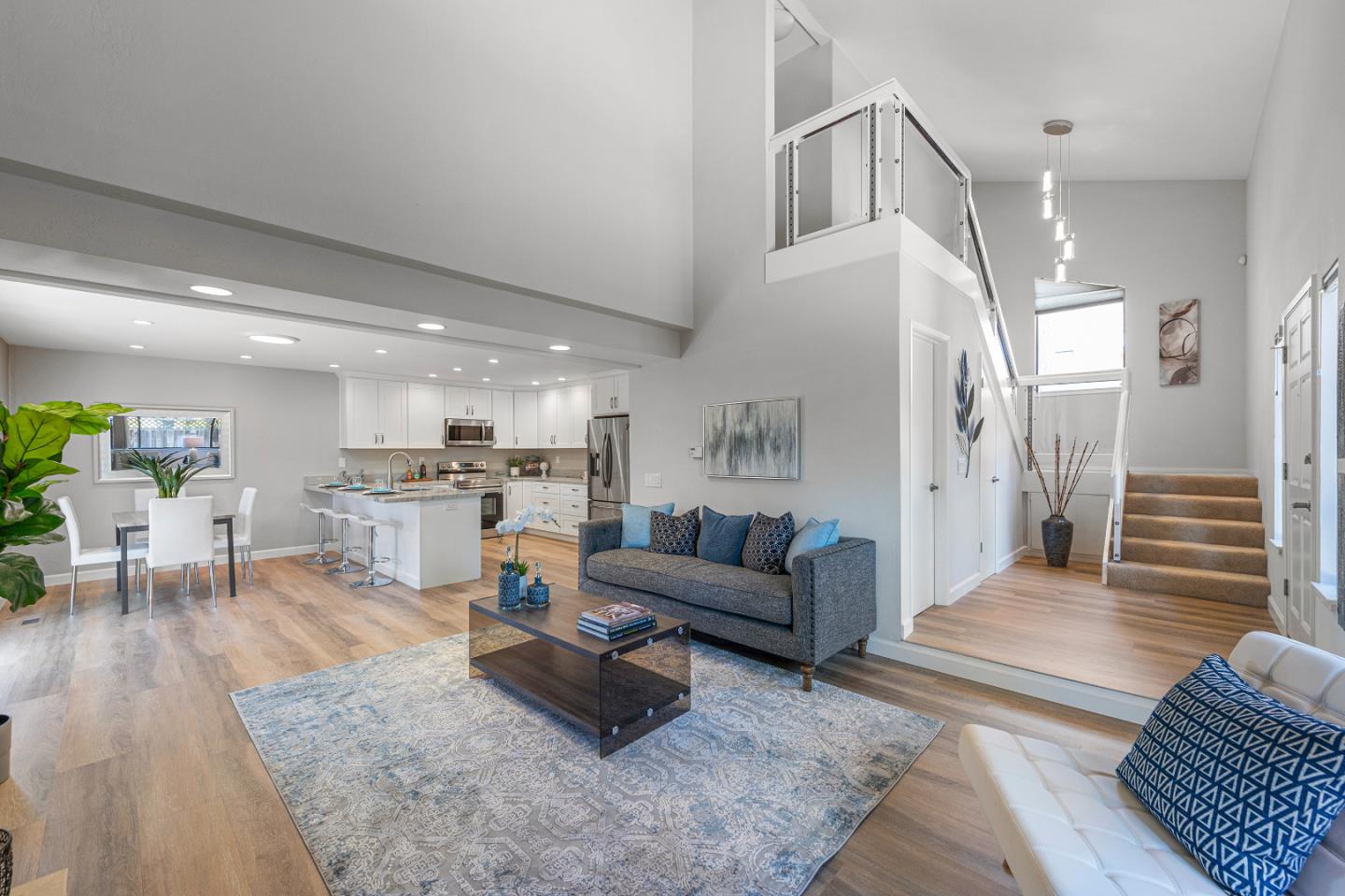 a living room with furniture and kitchen view