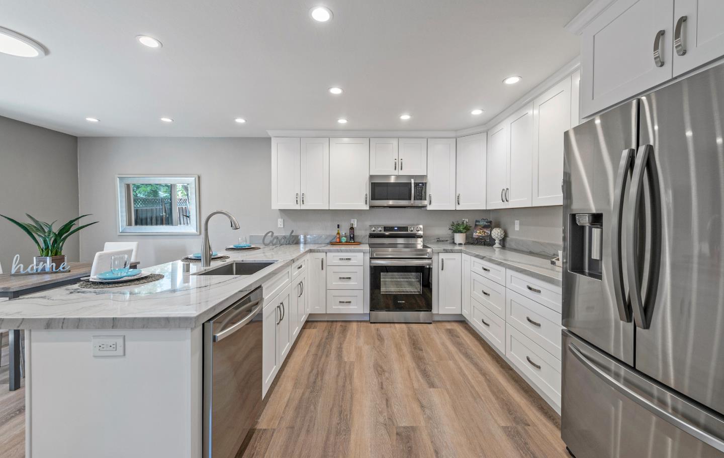 334 West Rincon Avenue Campbell, CA 95008 - Photo 11 of 25 a kitchen with stainless steel appliances granite countertop a refrigerator sink and stove