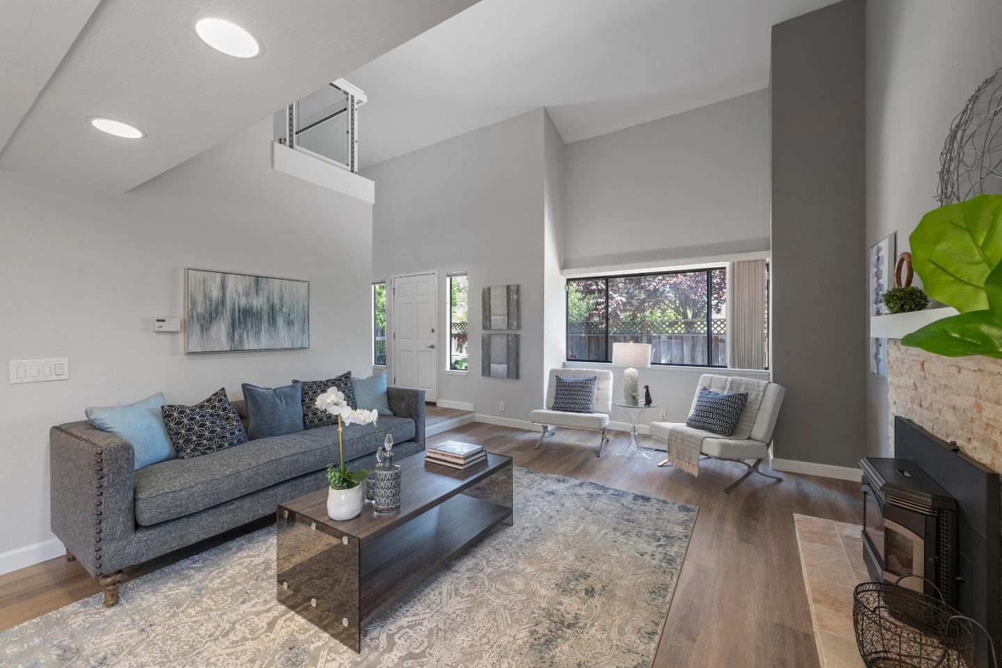 334 West Rincon Avenue Campbell, CA 95008 - Photo 7 of 25 a living room with furniture a large window and a fireplace