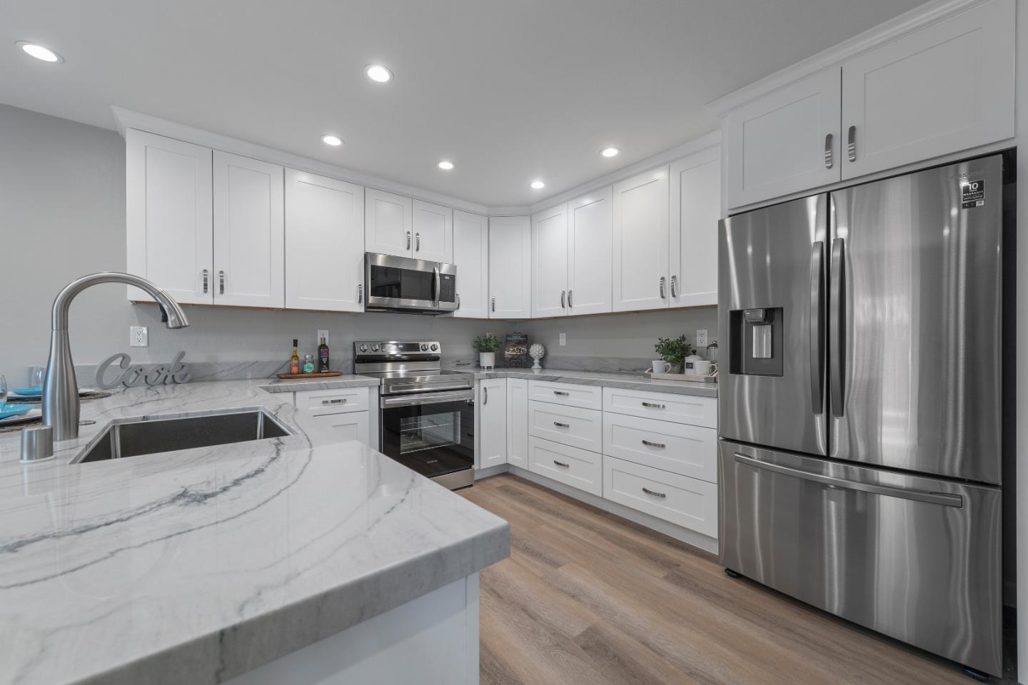 334 West Rincon Avenue Campbell, CA 95008 - Photo 9 of 25 a kitchen with granite countertop a refrigerator stove and sink