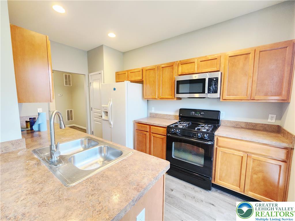 8513 Gateway Road Breinigsville, PA 18031 - Photo 23 of 45 A well-appointed kitchen features ample counter space, rich wooden cabinetry, and modern appliances.