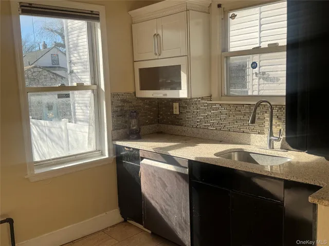 a kitchen with stainless steel appliances granite countertop a sink a stove and a microwave