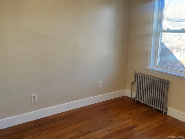 a view of a room with wooden floor and window