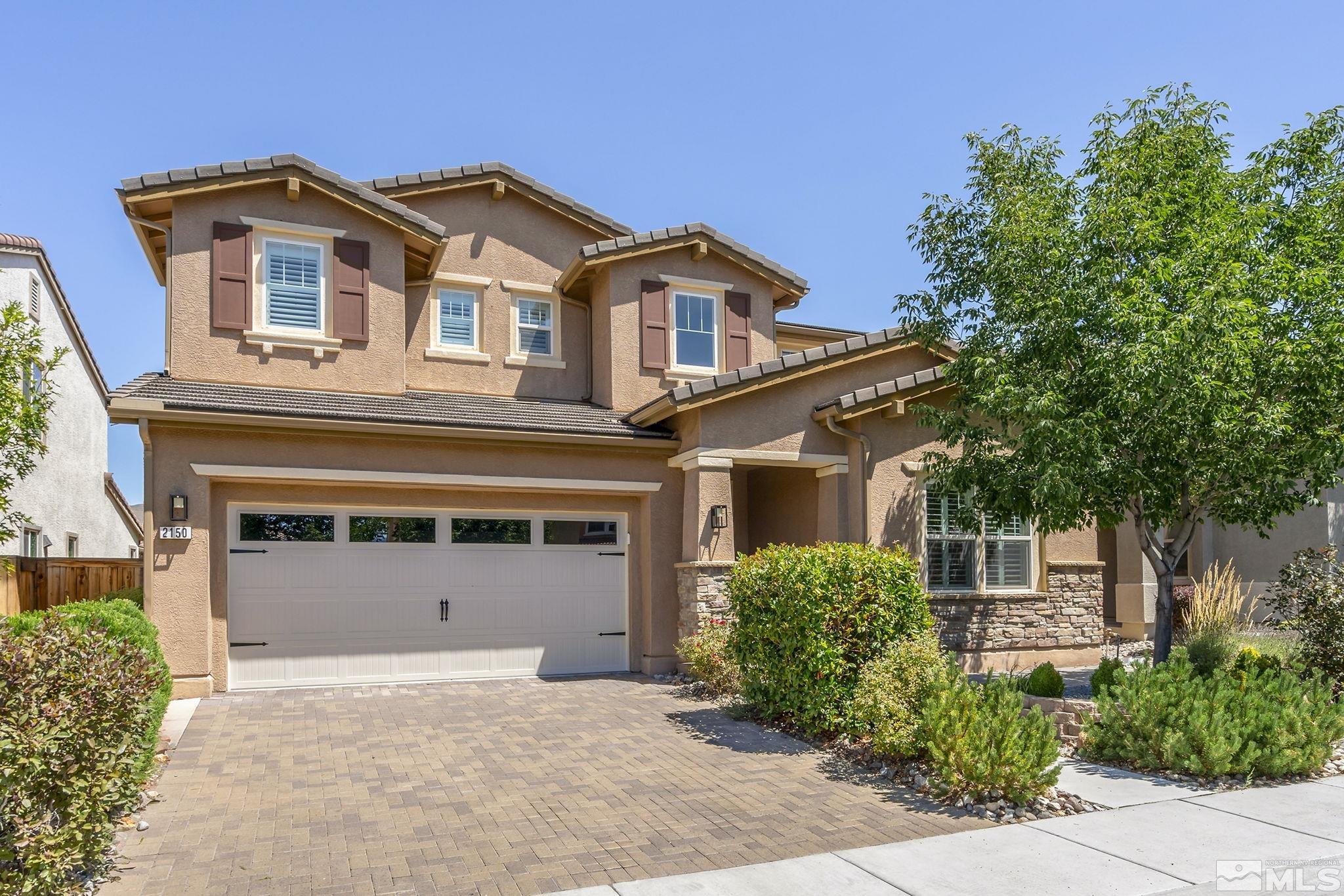 2150 Horse Prairie Road Reno, NV 89521 - Photo 1 of 31 a front view of a house with a yard and garage