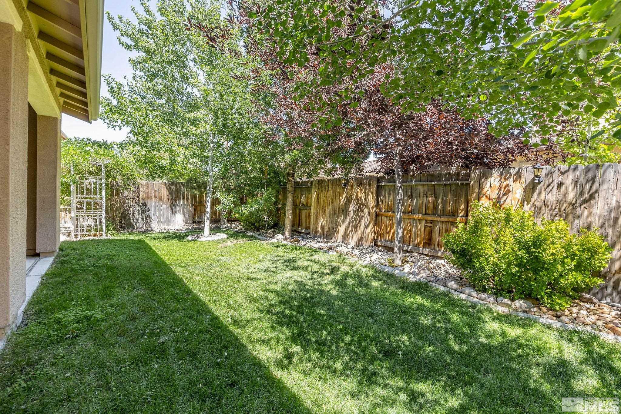 2150 Horse Prairie Road Reno, NV 89521 - Photo 31 of 31 a backyard of a house with lots of green space and fountain