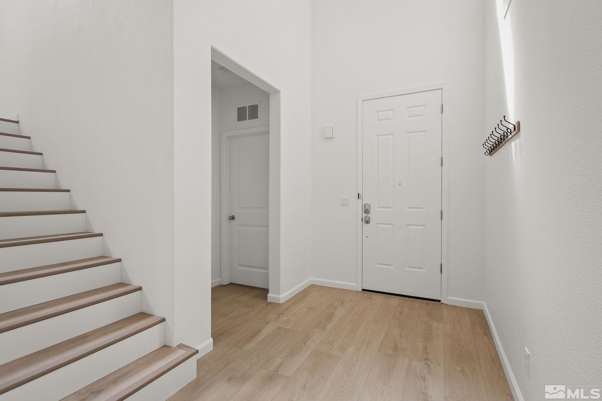 2150 Horse Prairie Road Reno, NV 89521 - Photo 4 of 31 a view of a hallway with wooden floor and entryway