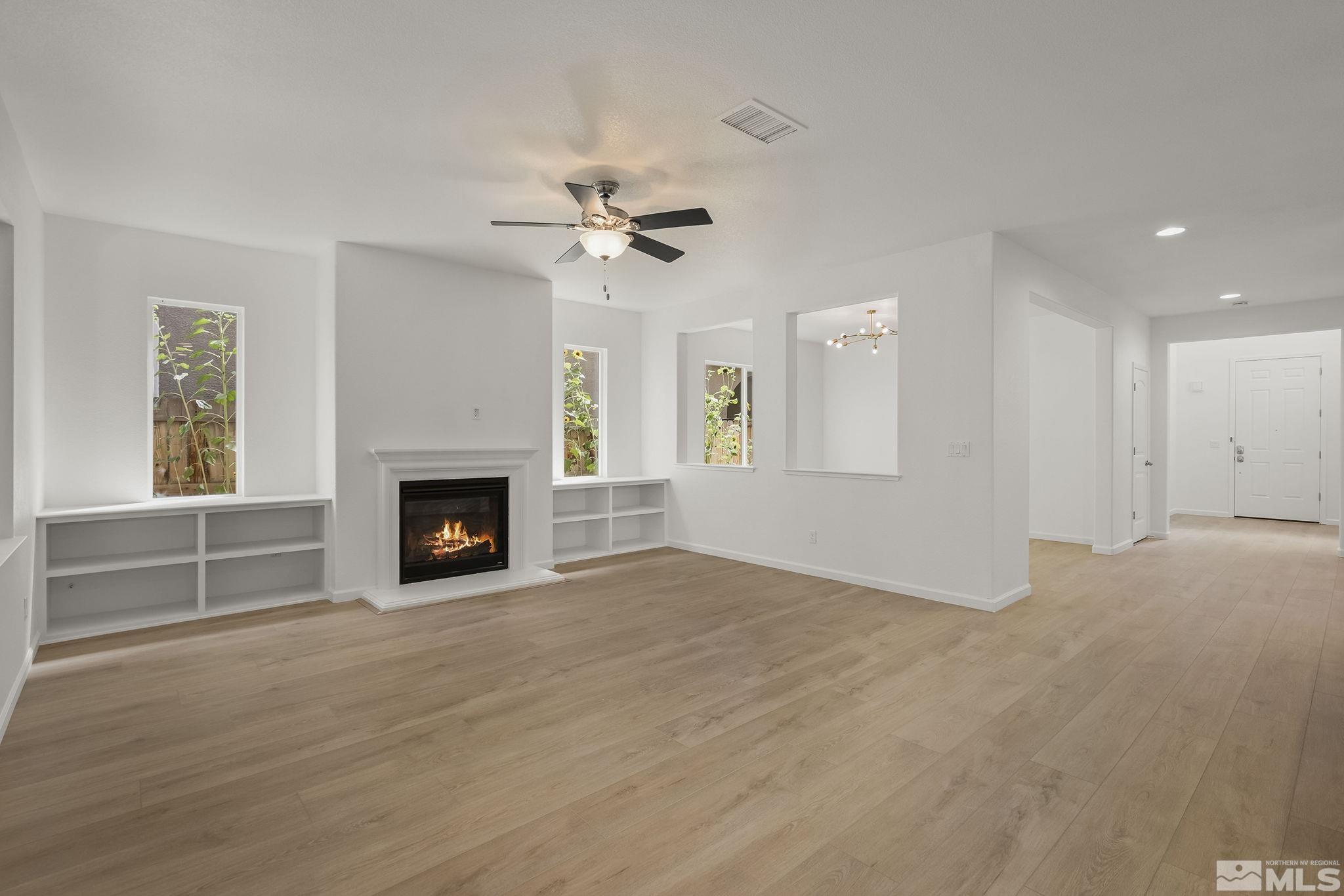 2150 Horse Prairie Road Reno, NV 89521 - Photo 5 of 31 a view of empty room with a fireplace and fan