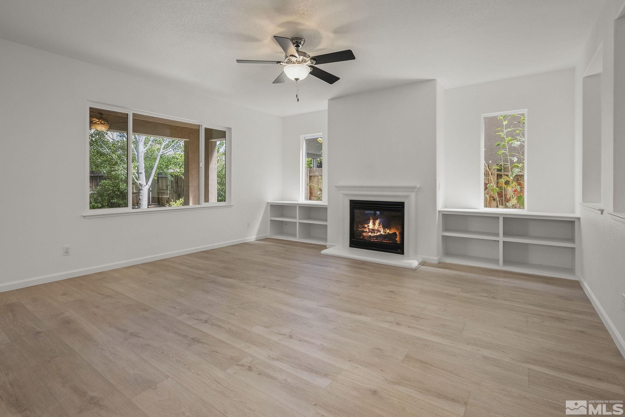2150 Horse Prairie Road Reno, NV 89521 - Photo 6 of 31 a view of an empty room with a fireplace and a window