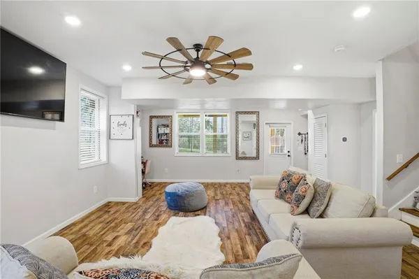 a living room with furniture and wooden floor