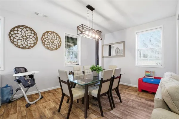 a dining room with furniture and window