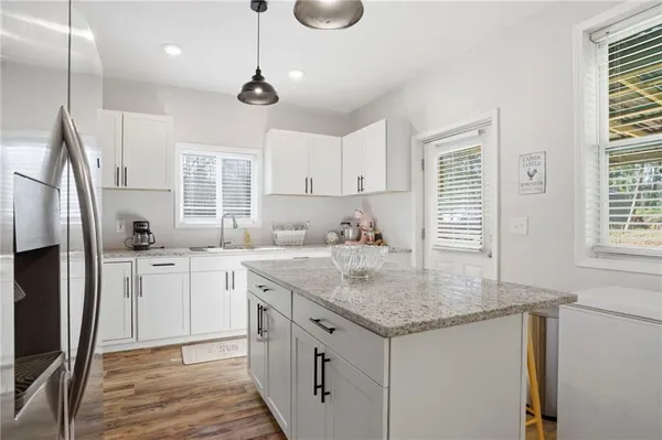 a kitchen that has a lot of cabinets in it and appliances