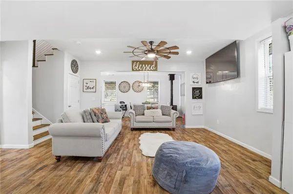 a living room with furniture and a wooden floor