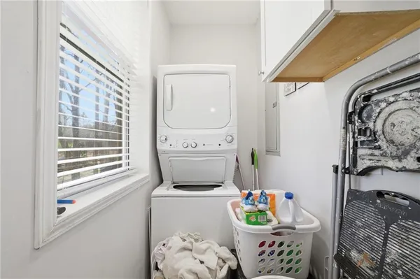 a bedroom with a bed a dresser and a window