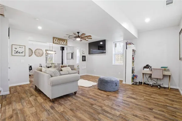 a living room with furniture and wooden floor