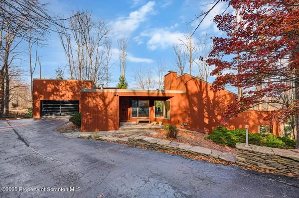 a view of a house with large trees