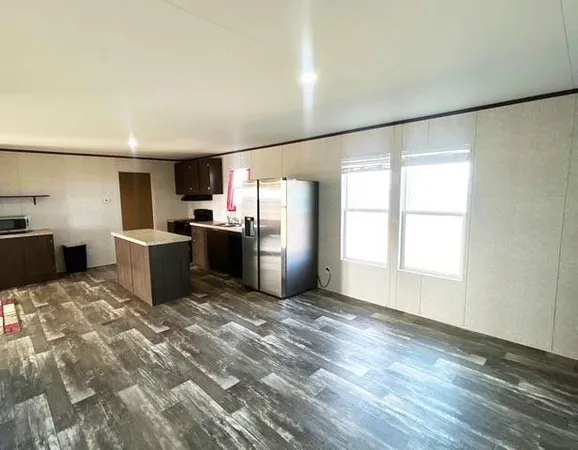 a kitchen with stainless steel appliances a refrigerator and a stove top oven