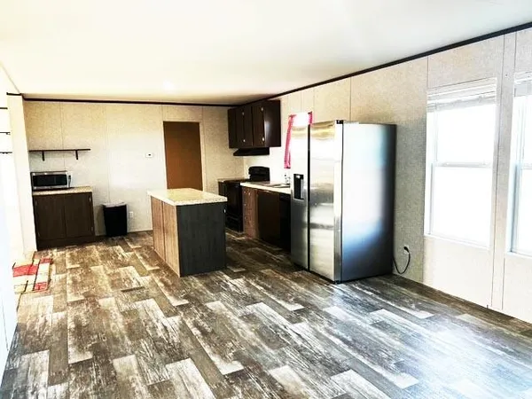 a kitchen with a refrigerator and a stove
