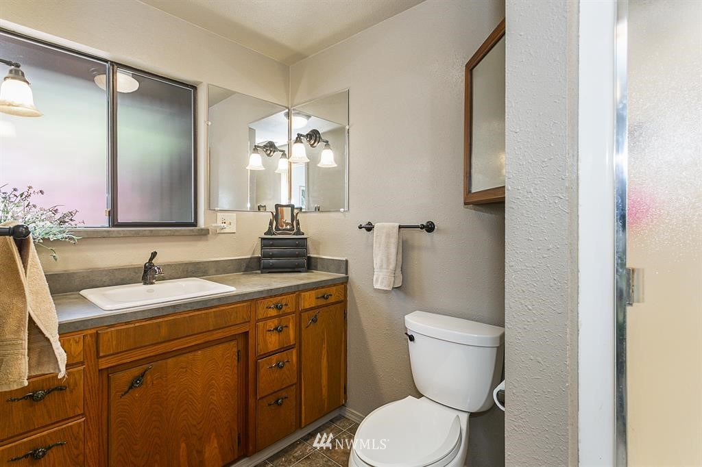 22016 High Bridge Road Monroe, WA 98272 - Photo 12 of 40 a bathroom with a toilet sink and mirror