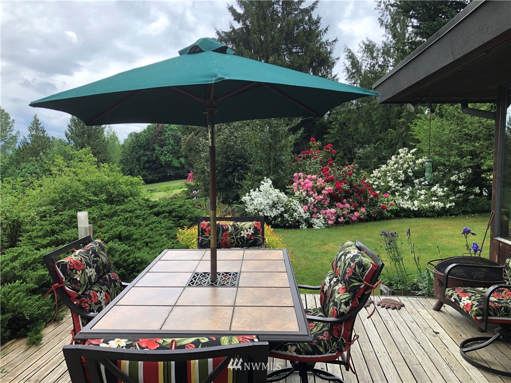 22016 High Bridge Road Monroe, WA 98272 - Photo 27 of 40 a view of a patio with chair and table under an umbrella