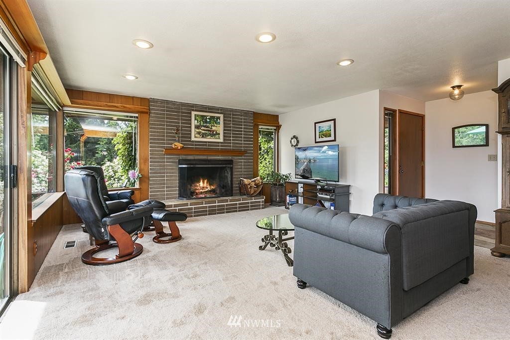 22016 High Bridge Road Monroe, WA 98272 - Photo 5 of 40 a living room with furniture a large window and a fireplace