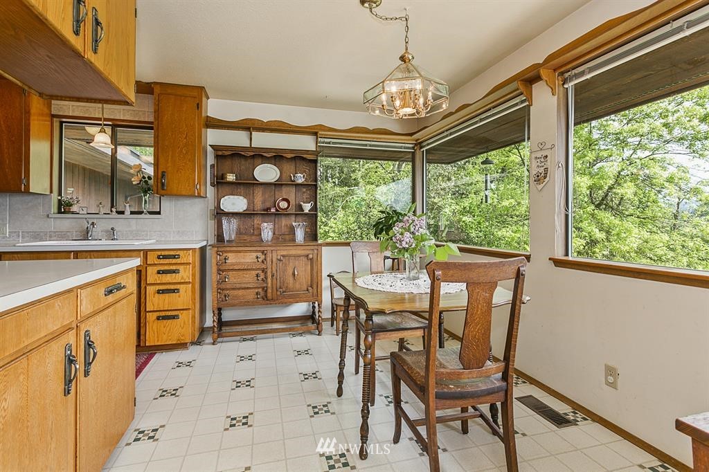 22016 High Bridge Road Monroe, WA 98272 - Photo 7 of 40 a view of a dining room with furniture a chandelier and window