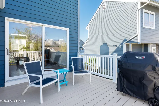 a kitchen with stainless steel appliances granite countertop a stove a refrigerator a microwave a dining table and chairs